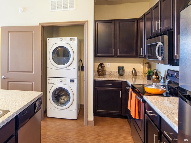a kitchen with a washer and dryer in it